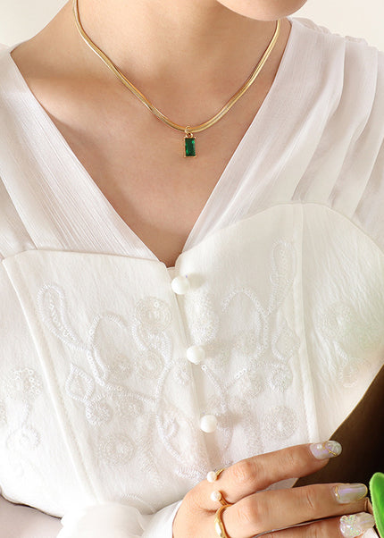 Japanese and Korean style niche design sense titanium steel gold-plated snake bone chain retro style light luxury emerald zircon pendant necklace