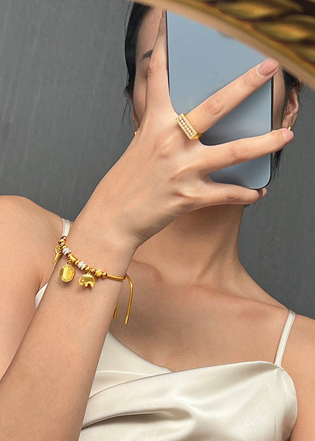 Cross-border hot-selling personality niche pull-out buckle jewelry, multi-element pendant, diamond-encrusted design, titanium steel gold-plated bracelet