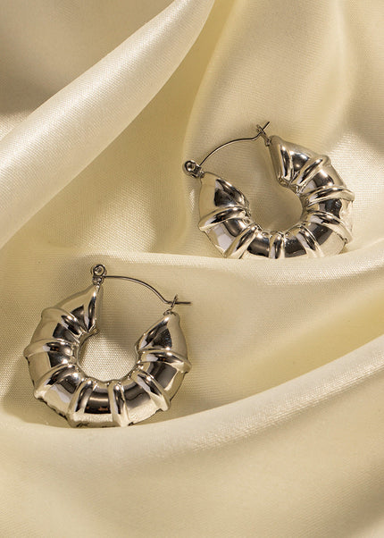 INS European and American new titanium steel earrings women's fashion versatile stainless steel winding hoops retro hollow earrings earrings