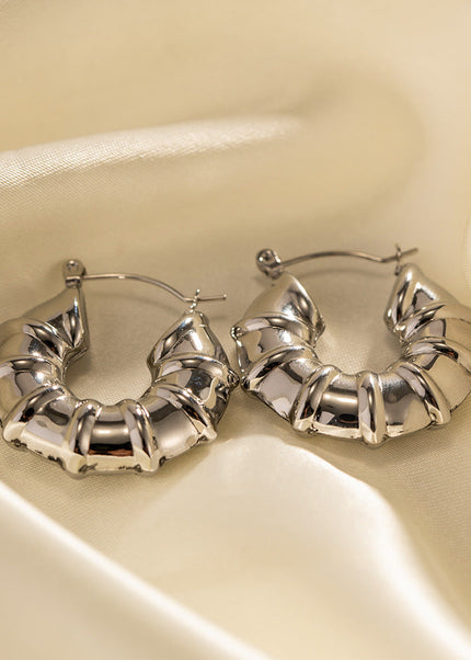 INS European and American new titanium steel earrings women's fashion versatile stainless steel winding hoops retro hollow earrings earrings