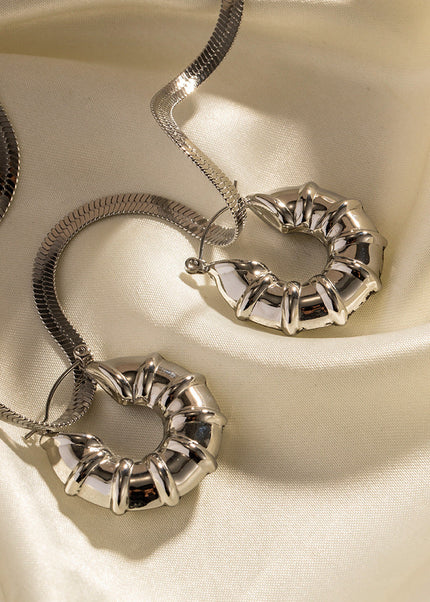 INS European and American new titanium steel earrings women's fashion versatile stainless steel winding hoops retro hollow earrings earrings