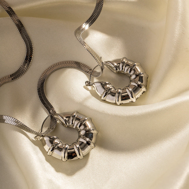 INS European and American new titanium steel earrings women's fashion versatile stainless steel winding hoops retro hollow earrings earrings